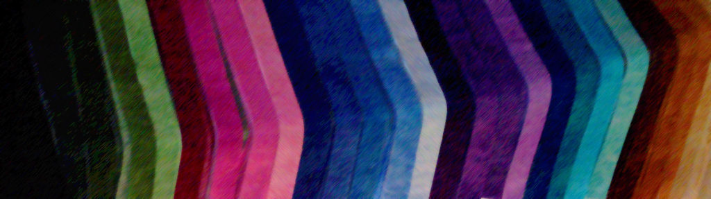 Rainbow layout of thing fabric strips: Green, pink, blue, purple, aqua, gold