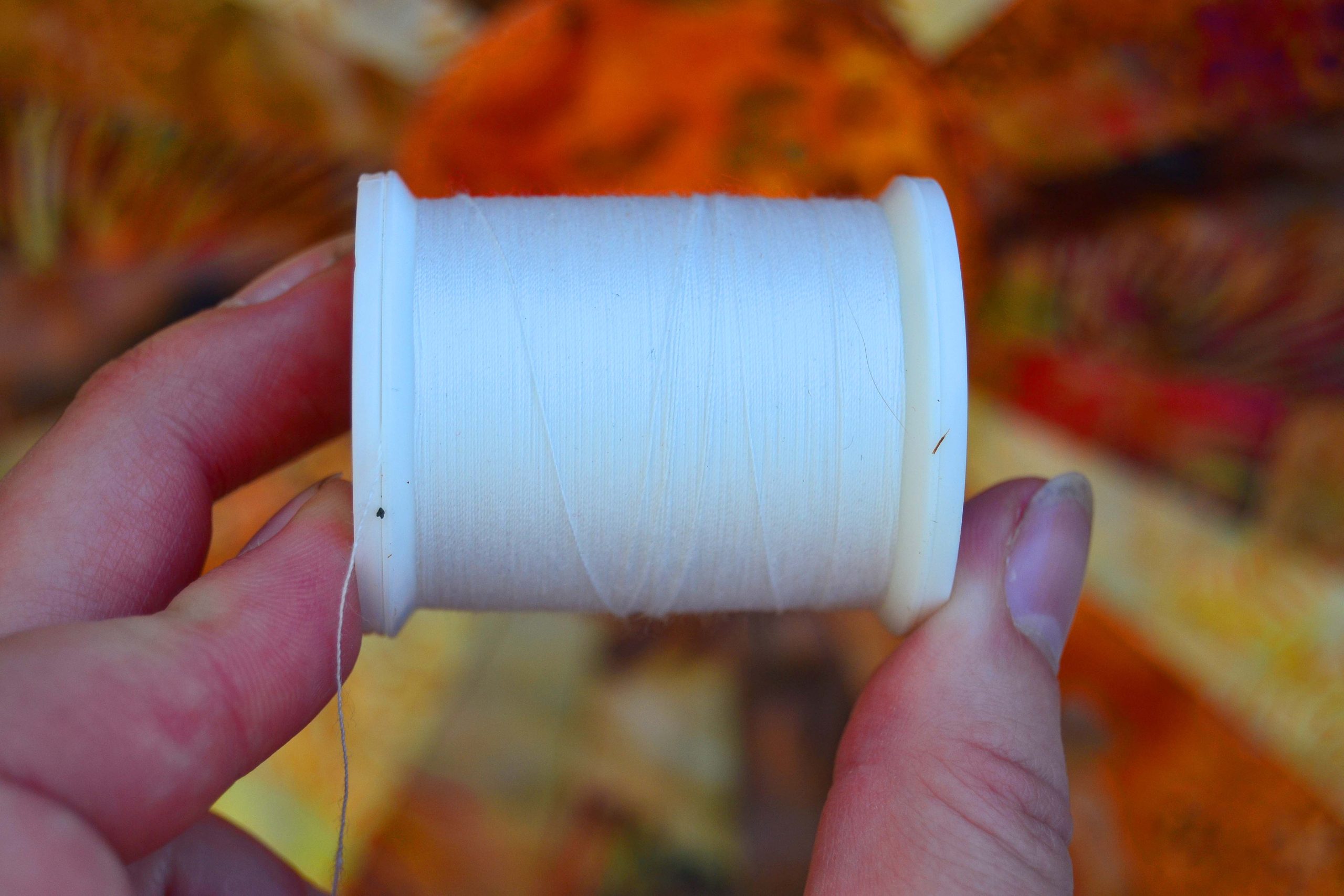 cream thread against an autumn table runner