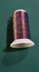Royal purple thread with flecks of metallic gold thread