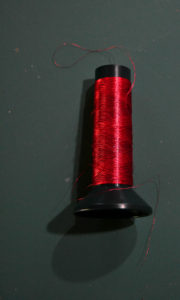 Super large spool of red metallic thread