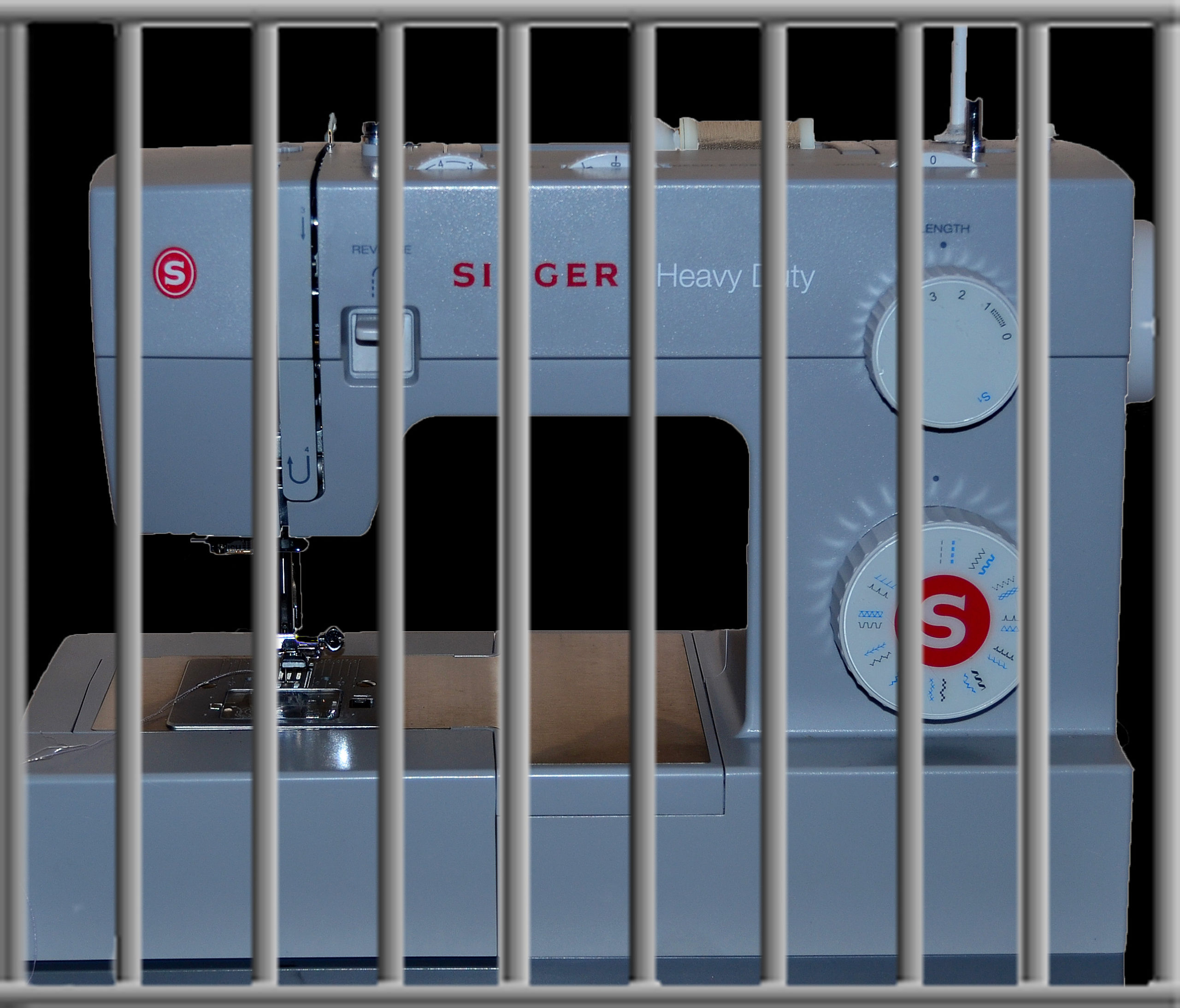 Singer sewing machine behind prison bars - representative of major sewing machine trouble