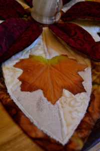 Rich golden brown maple leaf on a multi-cream background in our elegant autumn leaf candle holder