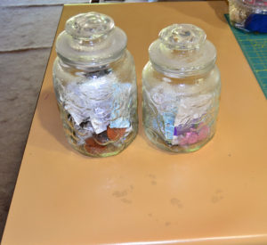 Old-fashioned crystal jars with solid lids used for corralling button clutter