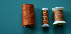 3 orange and yellow variegated thread spools