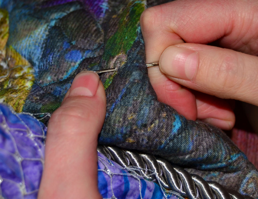 A needle sticking into the seamstress's finger - one of the consequences of sewing dangerously