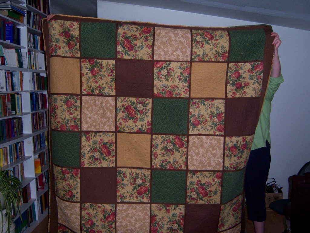 squares of alternating earth tone fabrics as a quilt backing