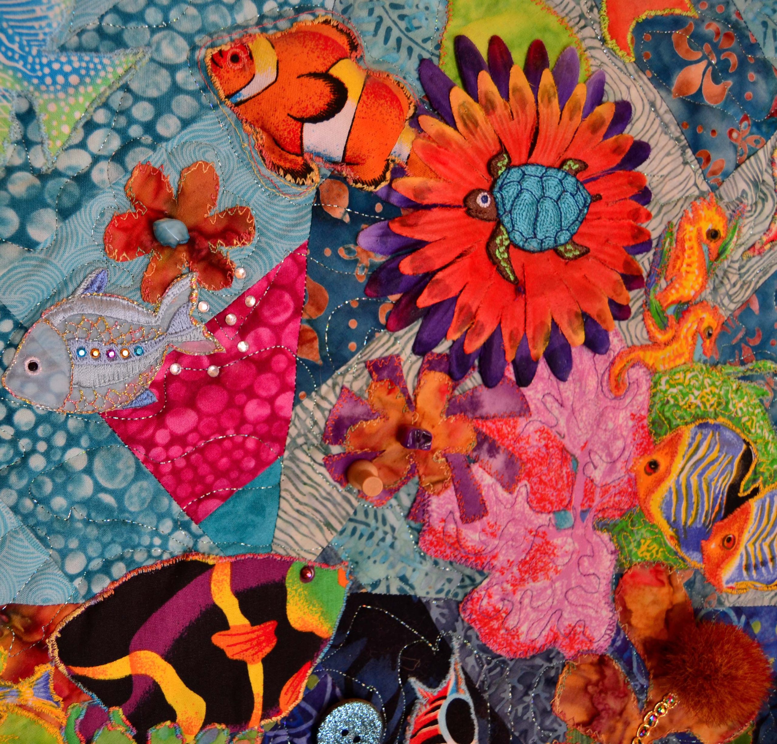 Tropical fish on a coral reef quilt. The quilt bursts and pops with 3-dimensional effect thanks to quilting foam