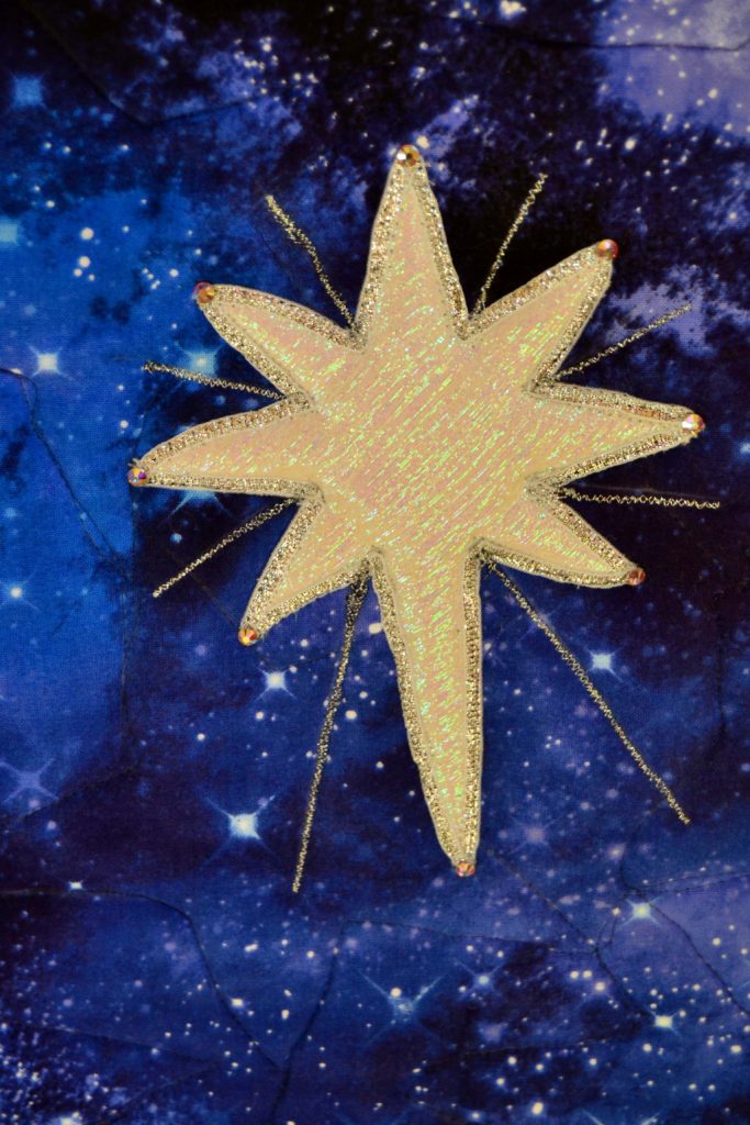 The white star of Bethlehem is popped up using quilting foam