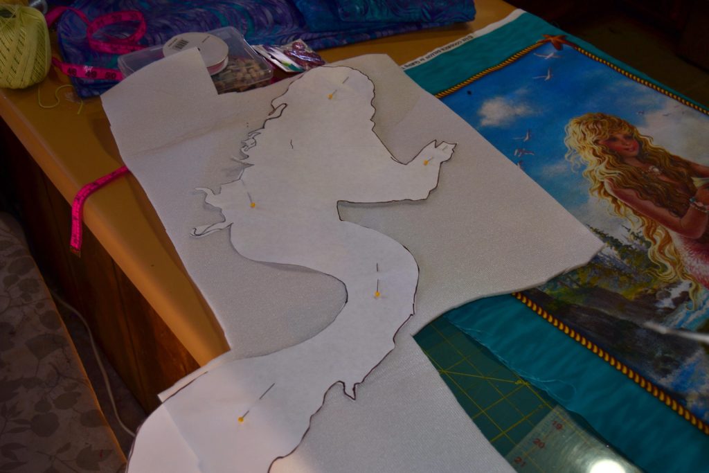 Quilting foam cut-out of mermaid shape, this effect will make the mermaid burst and pop out of her quilted panel when finished