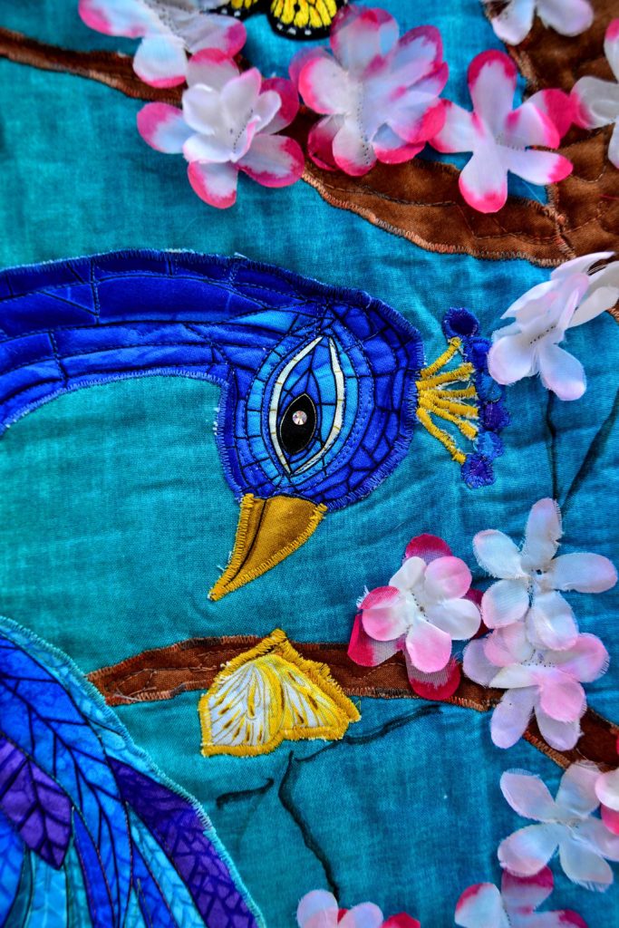 Peacock Paradis - fabric panels for quilting combined to create a brand-new image - close up of the original panel's printed peacock