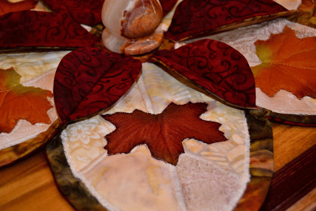 landscape quilt design - misty creams behind a red maple leaf