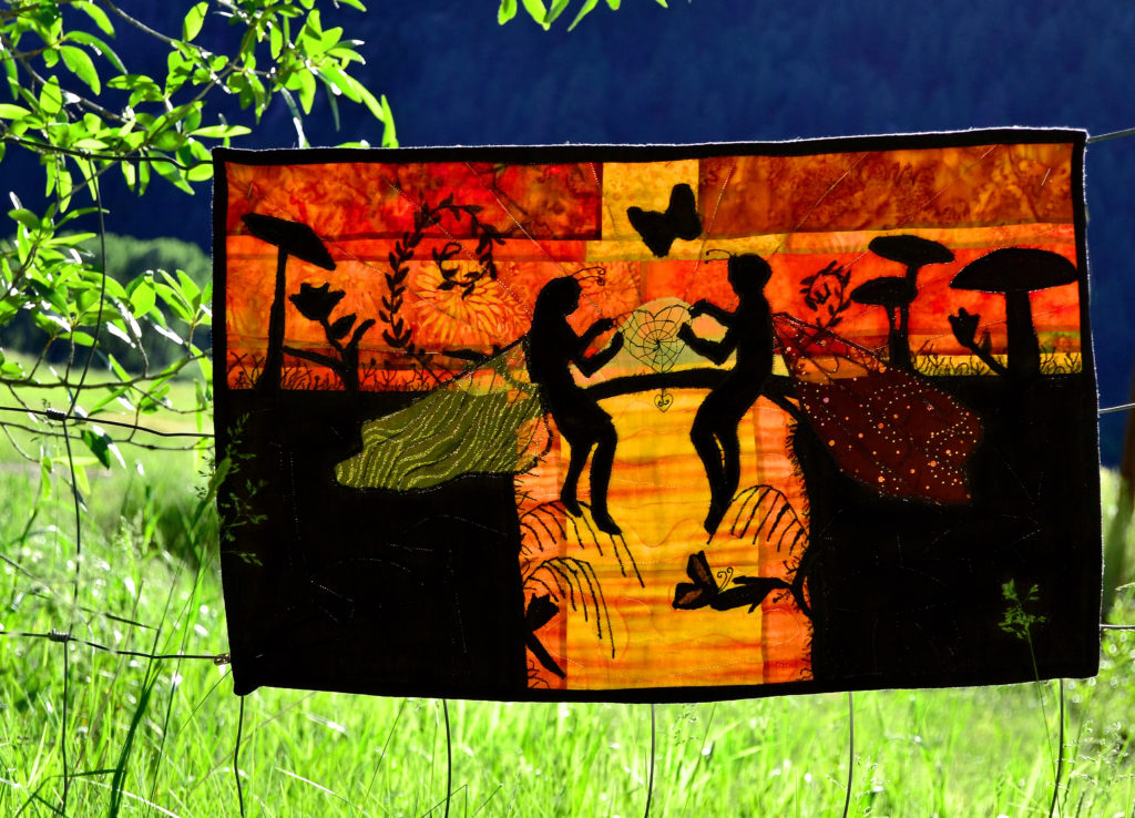 A fairy girl and boy sit weaving a spiderweb heart at sunset in one of our best ever landscape quilt designs