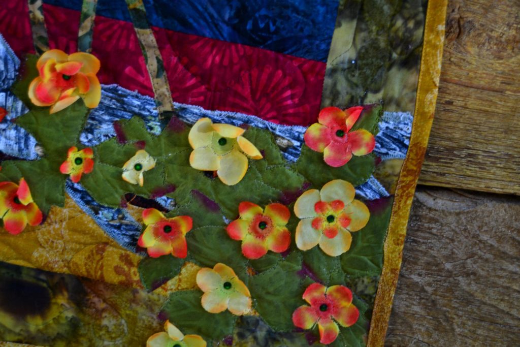 Small pinon flowers on a fabric panel creating quilting stories