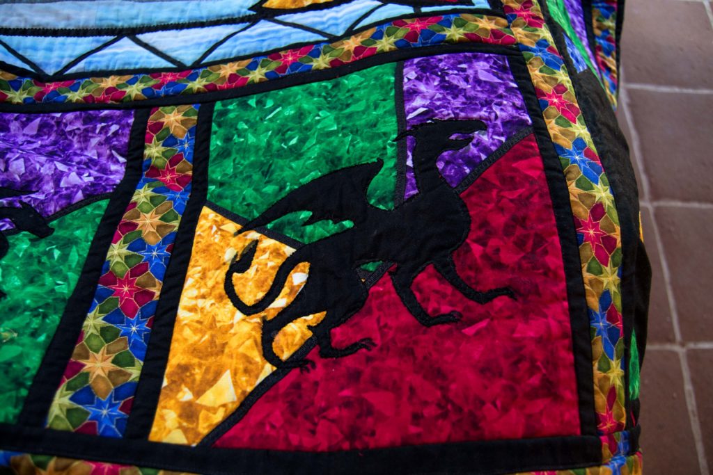 Black dragon silhouette in stained glass window