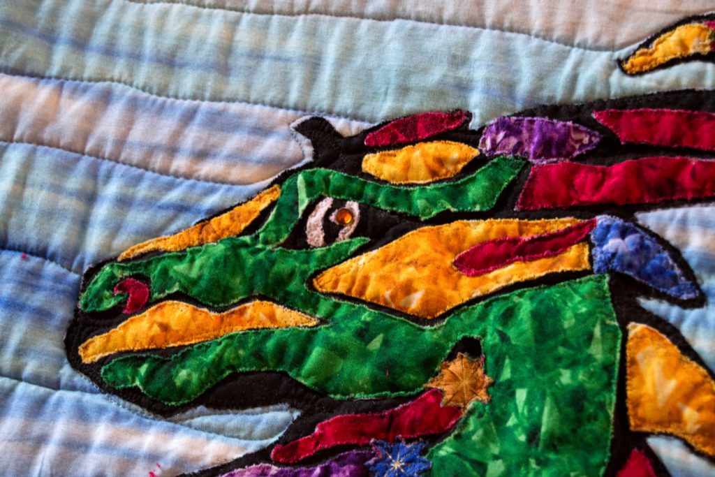Stained glass dragon head in quilt