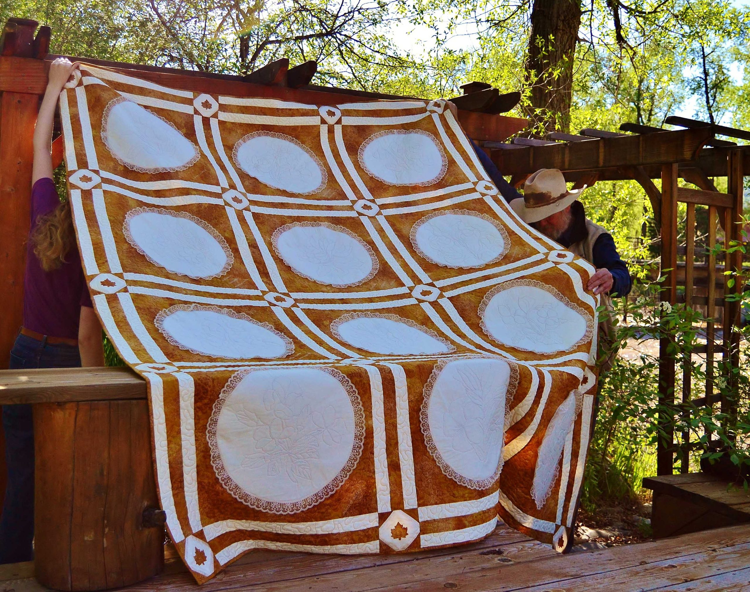 Golden and cream full queen quilt with flowers of Canada and maple leaves