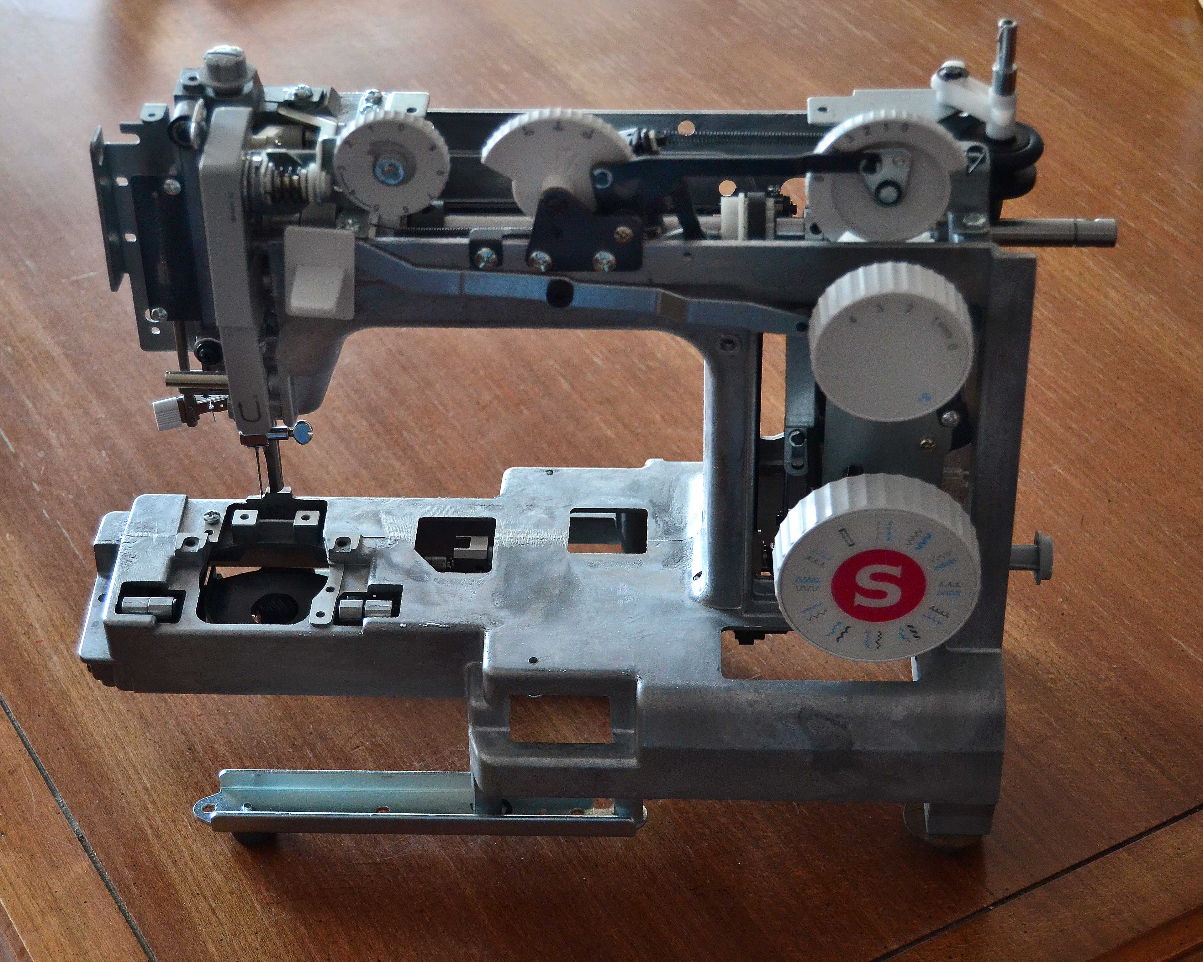 A sewing machine that's been stripped down to it's metal frame