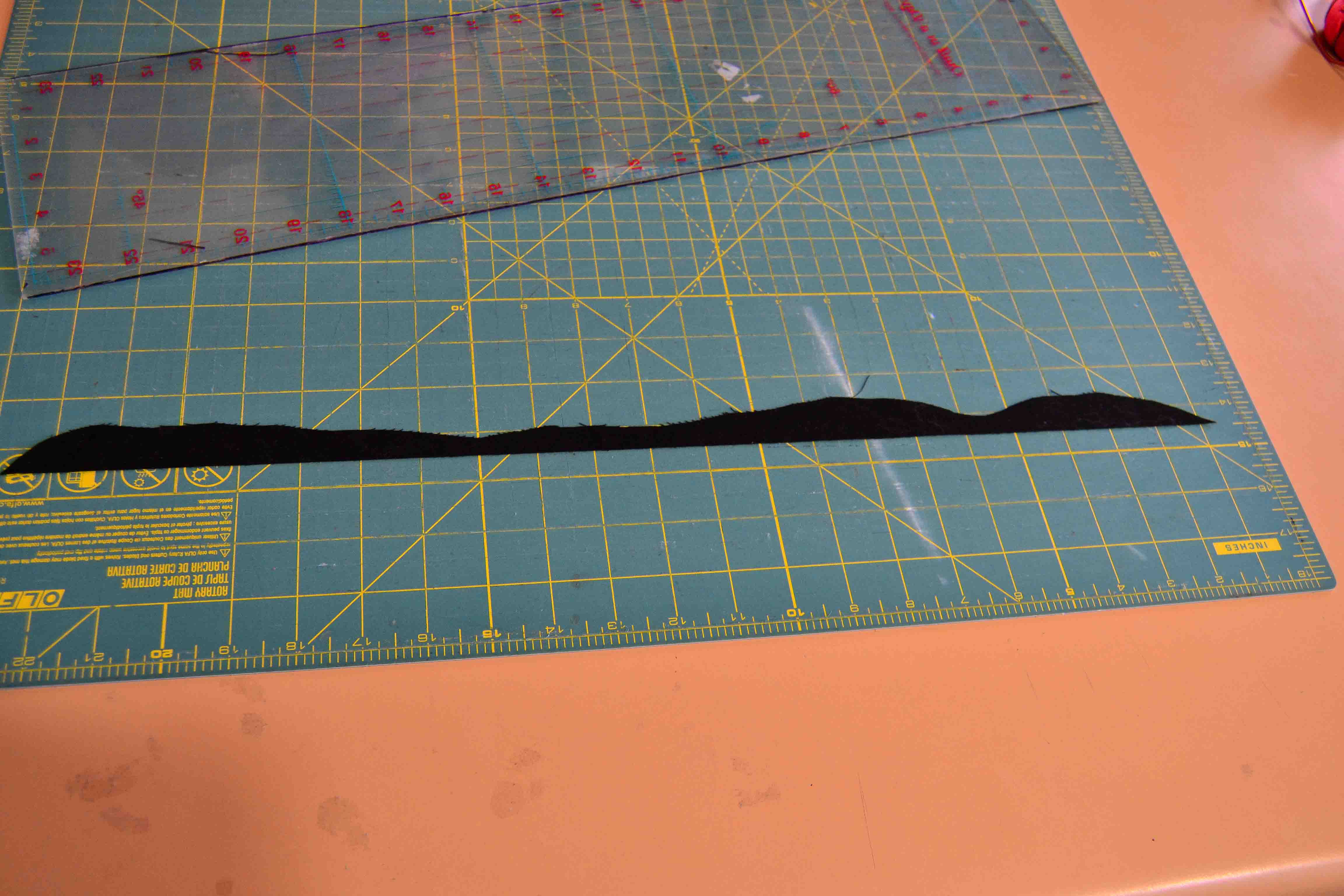 Show a green cutting board mat with hard clear ruler
