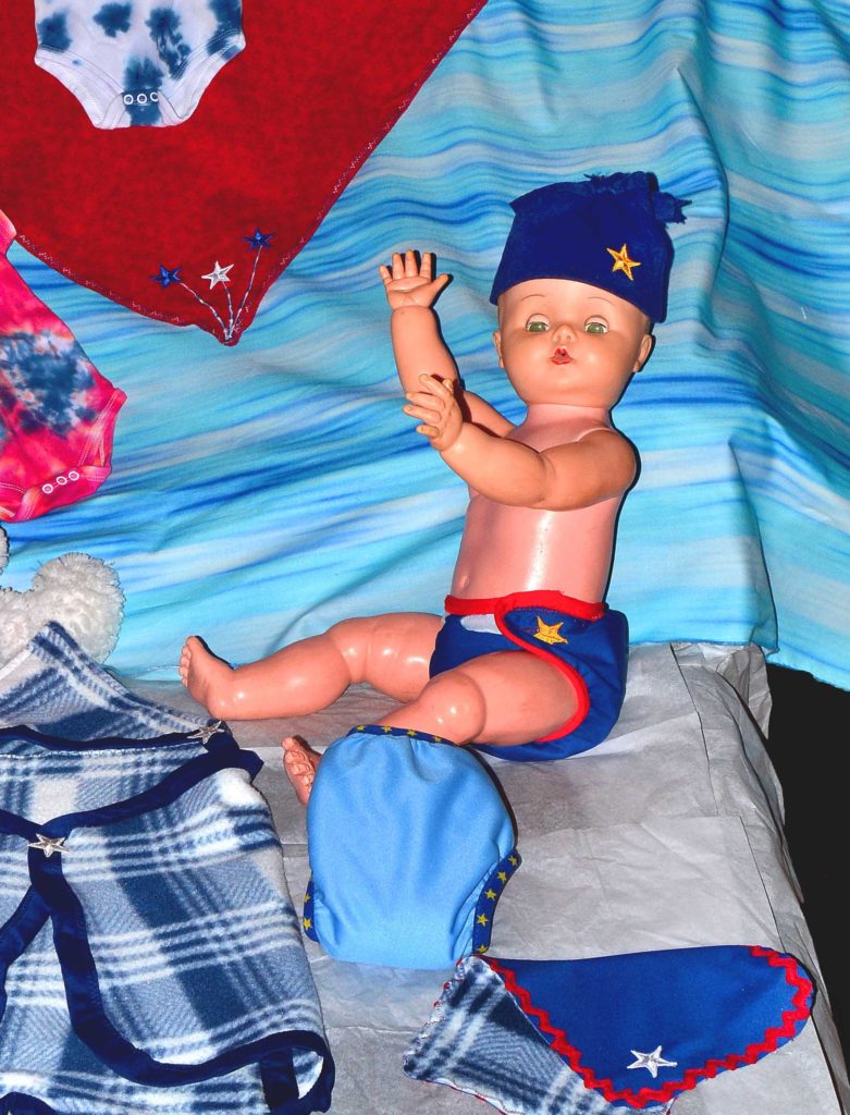 Doll with blue diapers