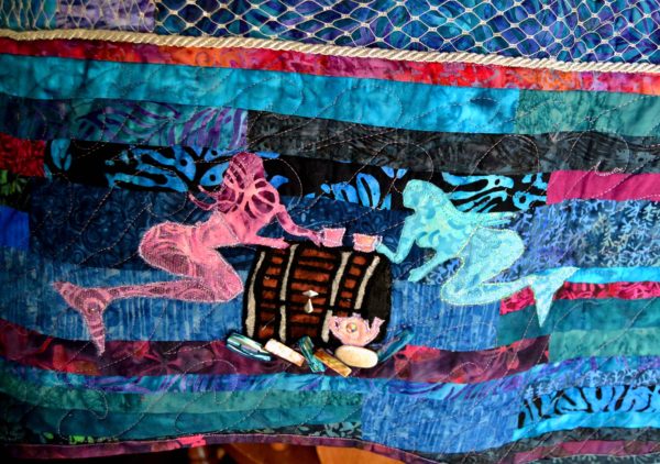 Pink and blue mermaids having a tea party on the ocean floor over a treasure chest