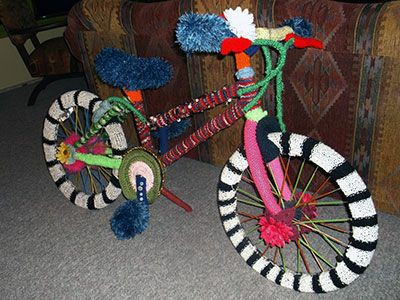 Large bicycle with striped yarnbombing wheels