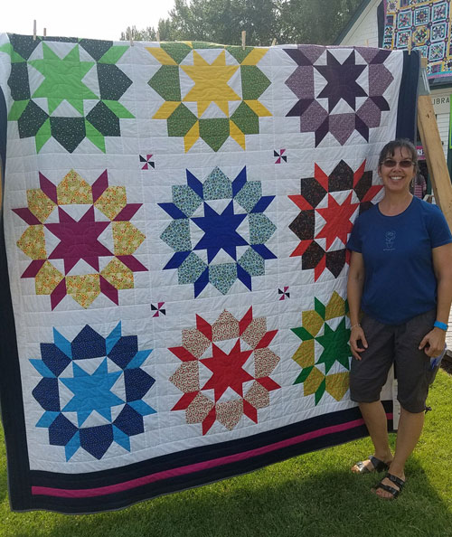 Shawnna Casazza with a star pattern quilt