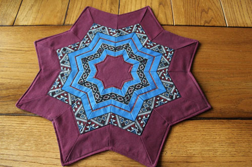 Turquoise and dusty red star shaped table topper