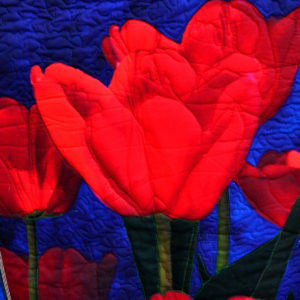 Brilliant red tulips on a blue background - intricate quilting - 3D foam effect