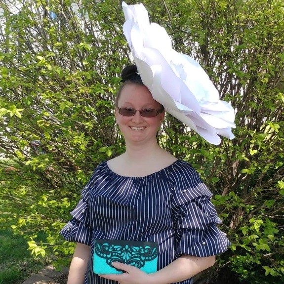 Unique Product Supplier Laura Piland with a big white flower as a hat