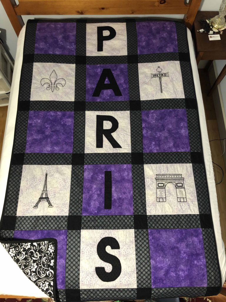 purple and white quilt blocks with PARIS written down the middle