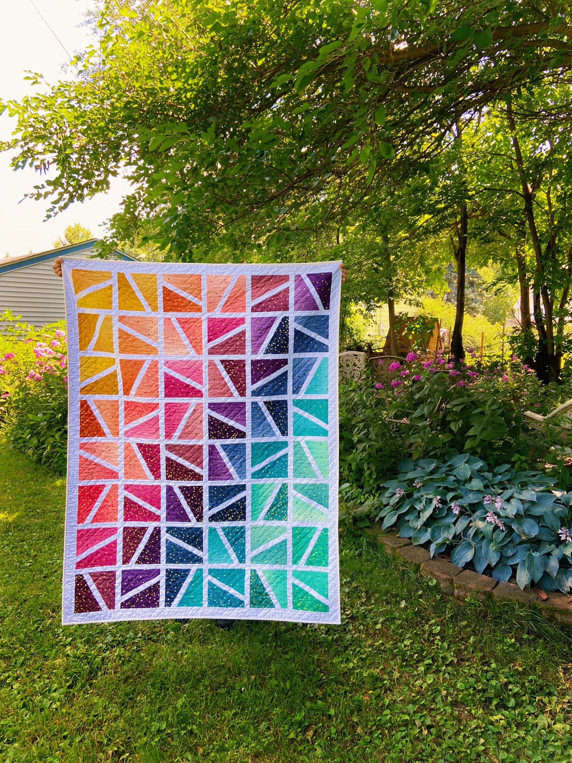 Unique geometric quilt designs by Kate Brown @ SparkleStash Designs - rainbow colored geometric design quilt